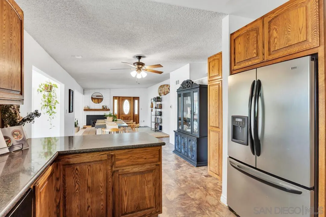 1347 Rex Lane El Cajon, CA 92021 - Photo 12 of 57 a kitchen with stainless steel appliances granite countertop a refrigerator and a sink