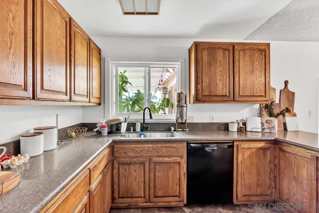 1347 Rex Lane El Cajon, CA 92021 - Photo 14 of 57 a kitchen with stainless steel appliances granite countertop a sink stove and cabinets