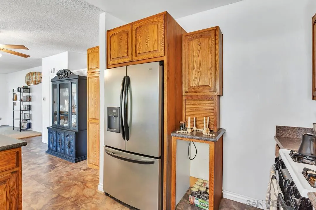 1347 Rex Lane El Cajon, CA 92021 - Photo 15 of 57 a metallic refrigerator freezer sitting in a kitchen