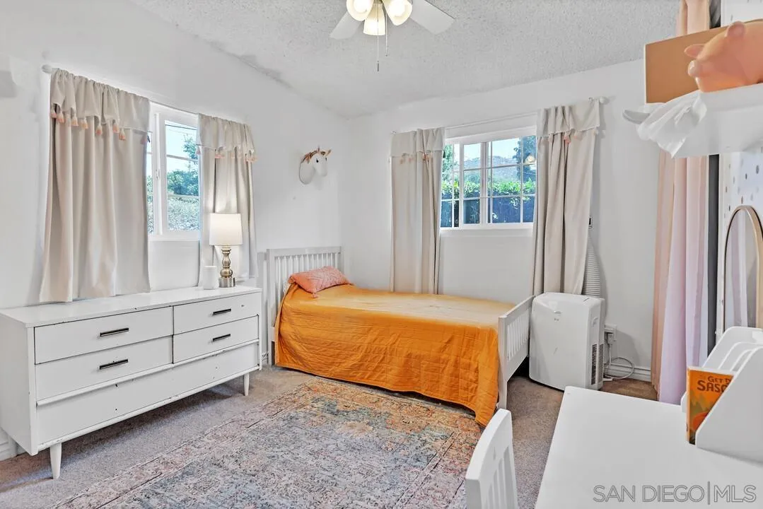 1347 Rex Lane El Cajon, CA 92021 - Photo 26 of 57 a bedroom with a bed and a chandelier