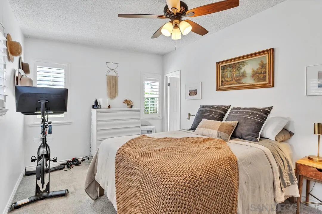 1347 Rex Lane El Cajon, CA 92021 - Photo 32 of 57 a bedroom with bed and a chandelier