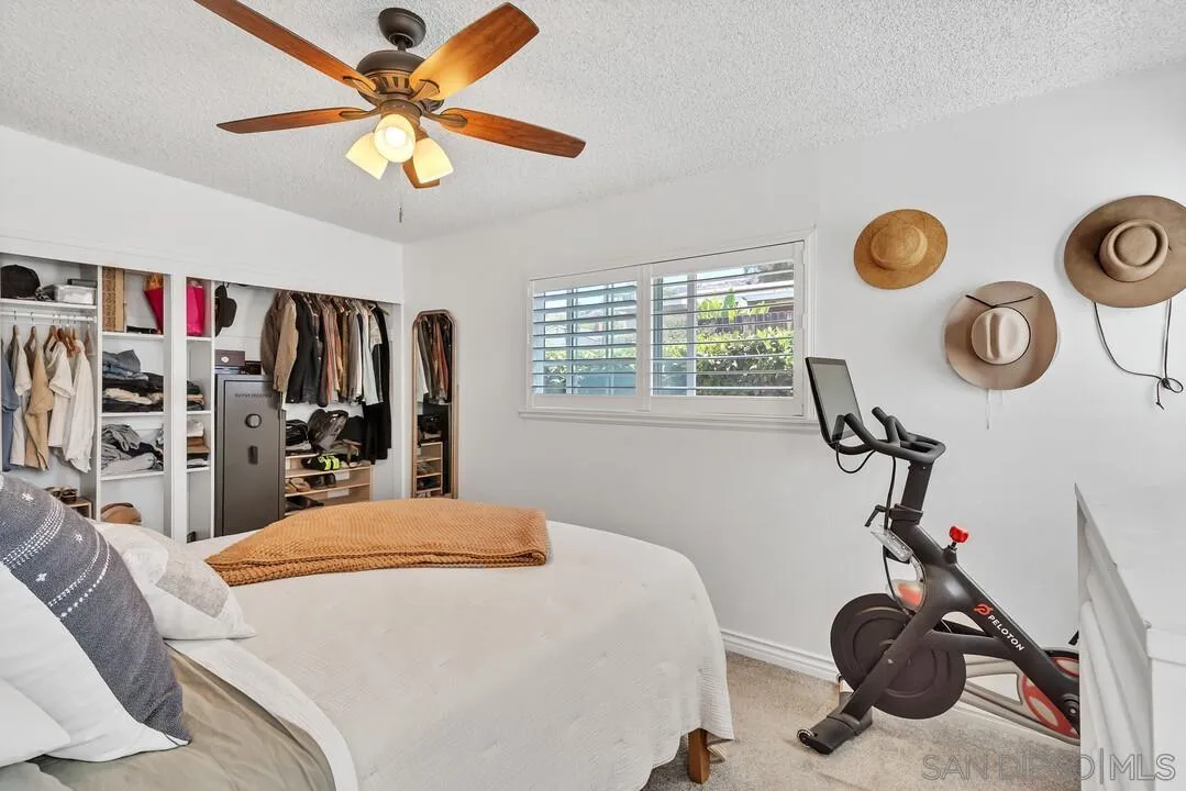 1347 Rex Lane El Cajon, CA 92021 - Photo 34 of 57 a bedroom with a bed and a chandelier