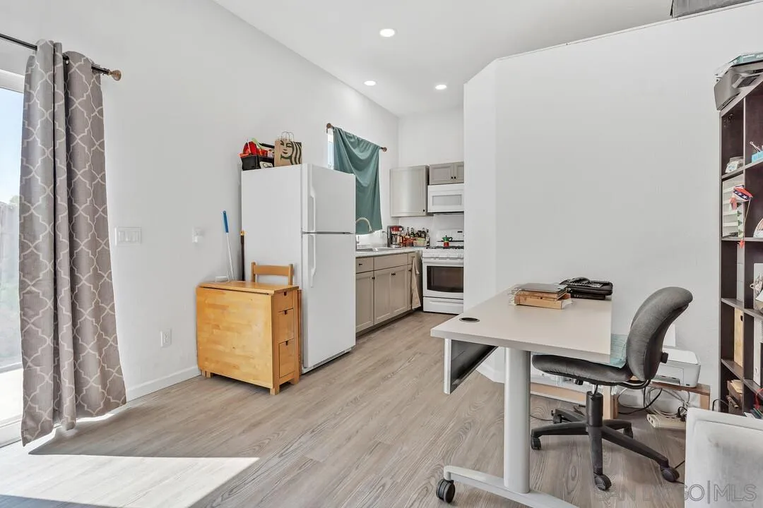 1347 Rex Lane El Cajon, CA 92021 - Photo 47 of 57 a room with furniture a refrigerator and a table