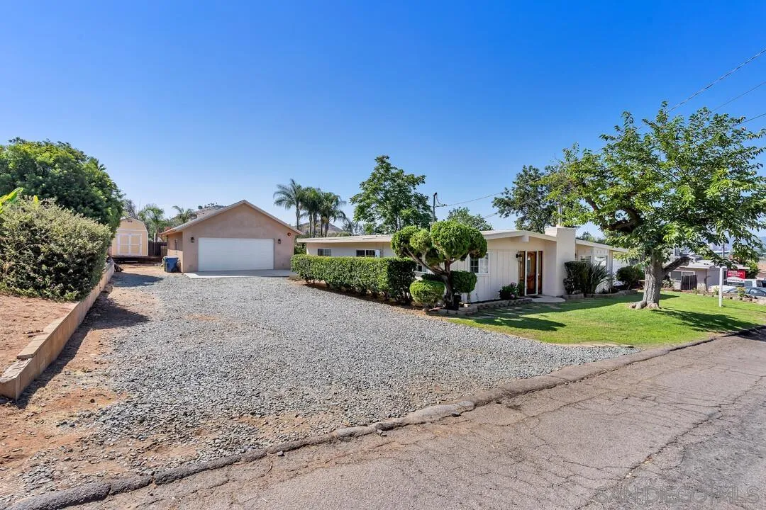 1347 Rex Lane El Cajon, CA 92021 - Photo 5 of 57 a front view of a house with a yard and garage