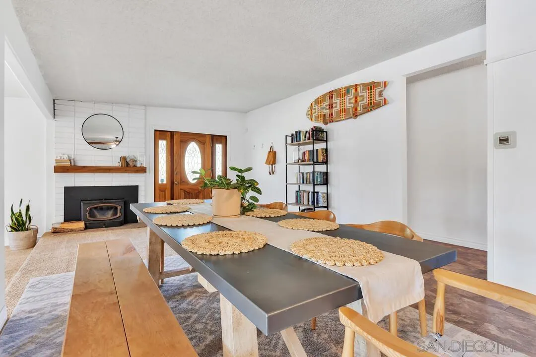 1347 Rex Lane El Cajon, CA 92021 - Photo 10 of 57 a dinning table and a fireplace in a room