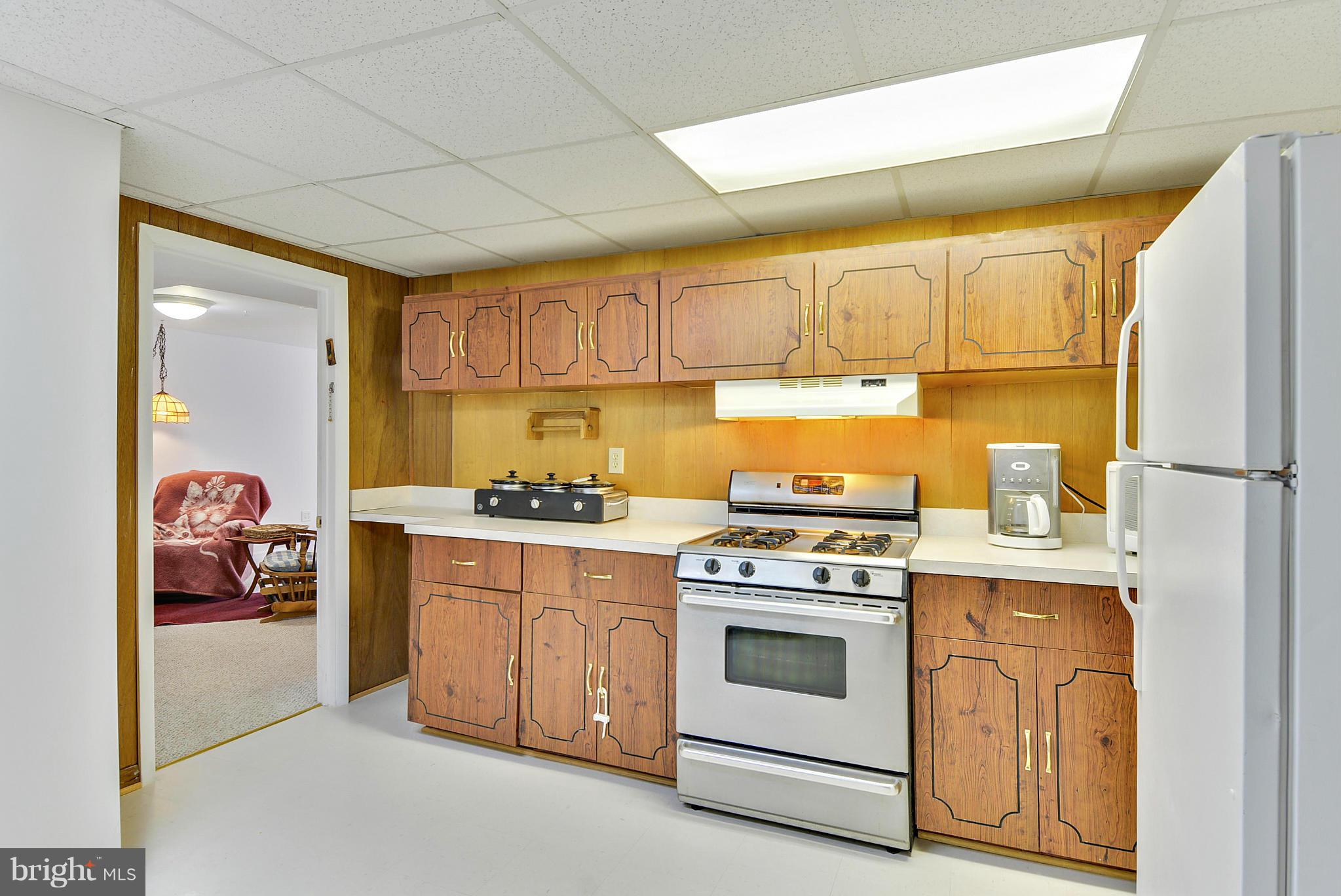 11113 Lombardy Road Silver Spring, MD 20901 - Photo 23 of 30 a kitchen with stainless steel appliances granite countertop a stove a sink and a refrigerator