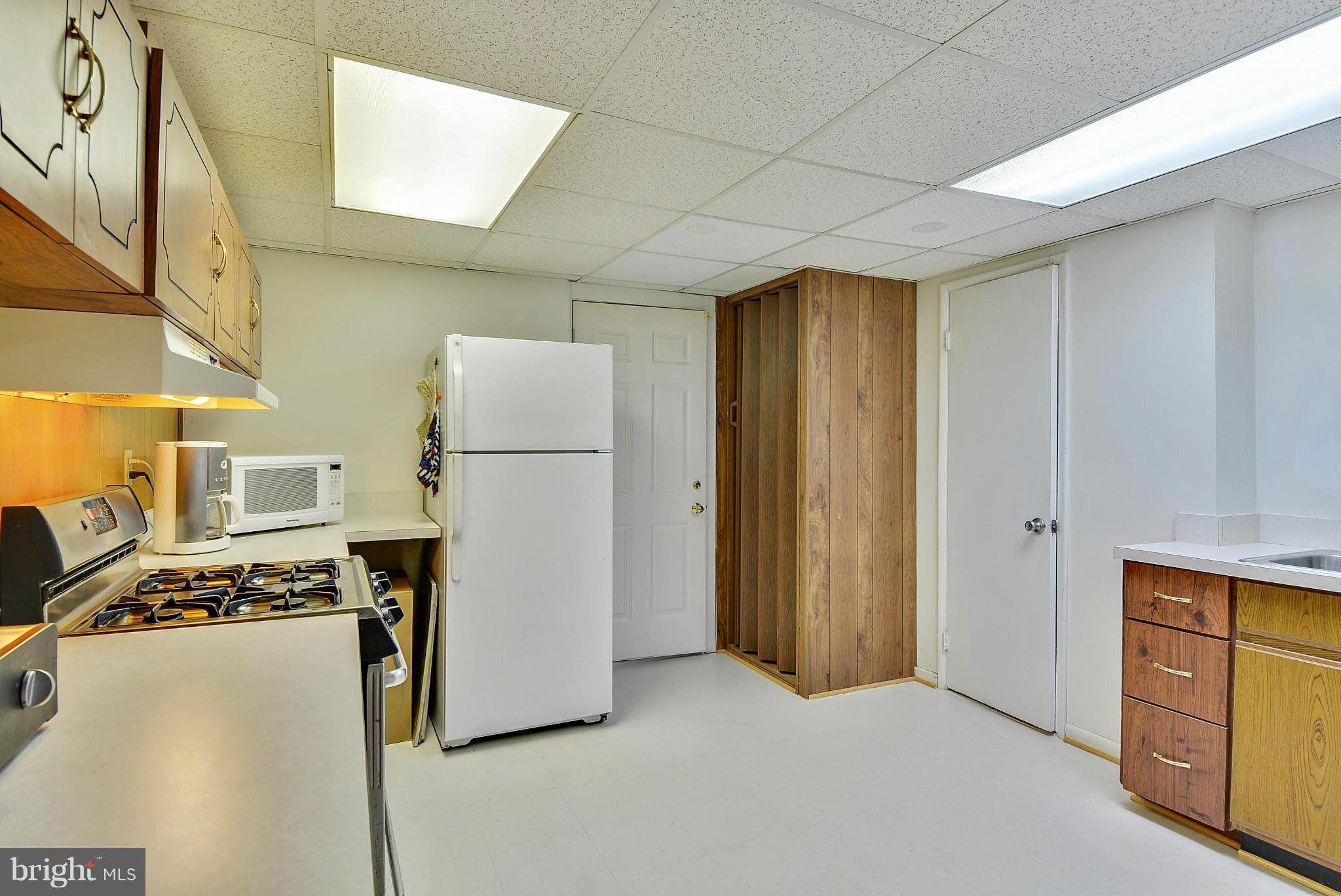 11113 Lombardy Road Silver Spring, MD 20901 - Photo 24 of 30 a view of kitchen with refrigerator stove and wooden cabinets