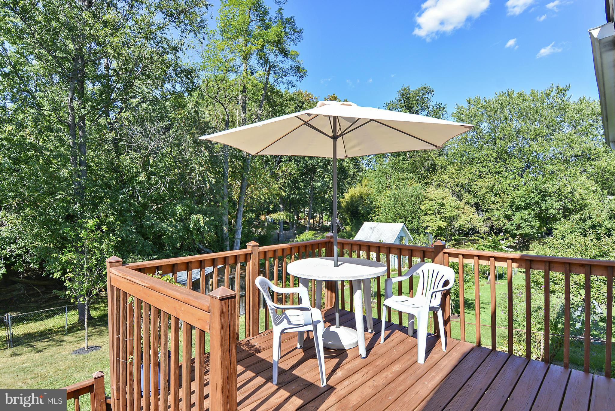 11113 Lombardy Road Silver Spring, MD 20901 - Photo 27 of 30 a view of balcony with wooden floor and outdoor seating
