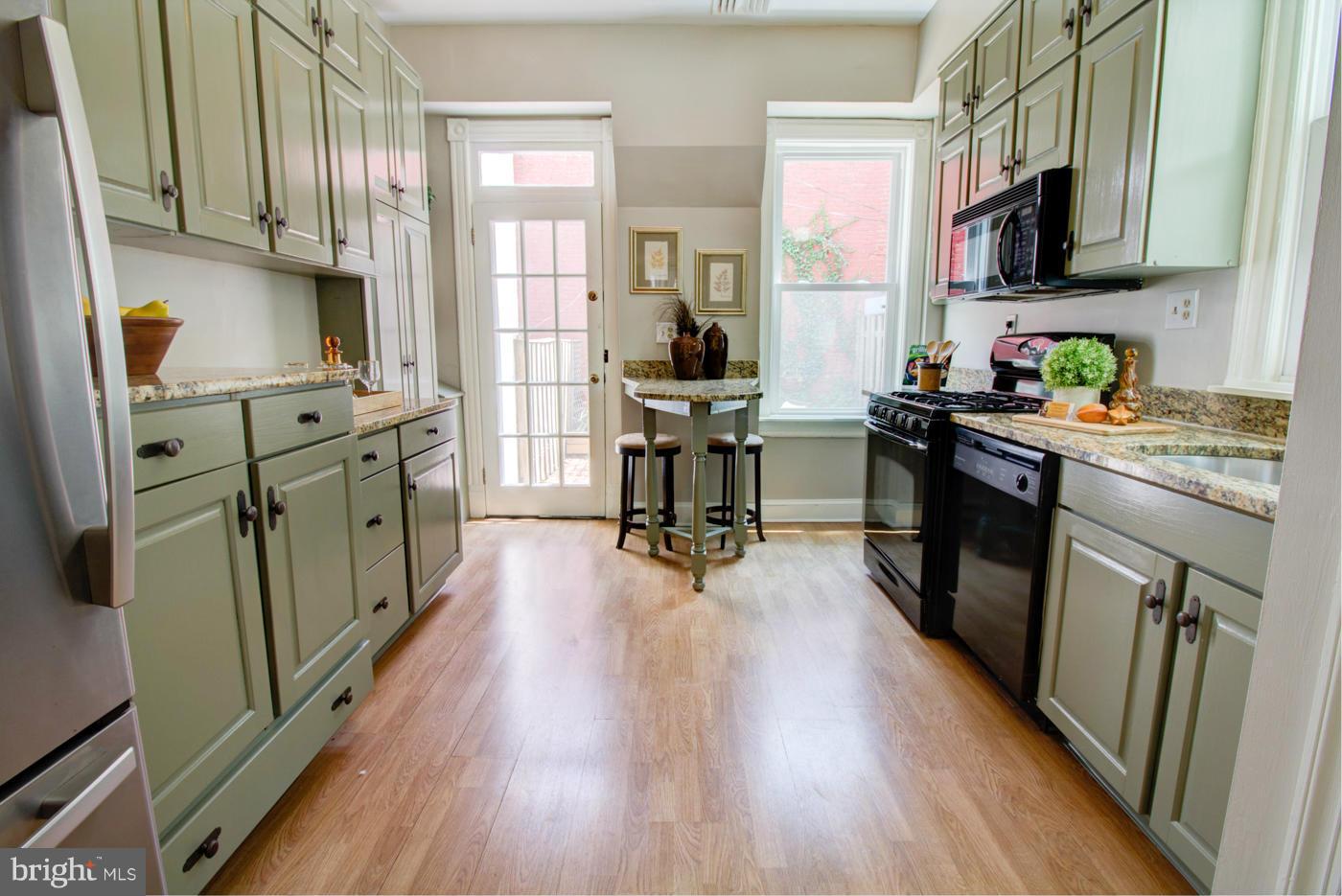 509 6th Street Northeast Washington, DC 20002 - Photo 12 of 30 a kitchen with stainless steel appliances a stove top oven a sink a refrigerator cabinets and wooden floor