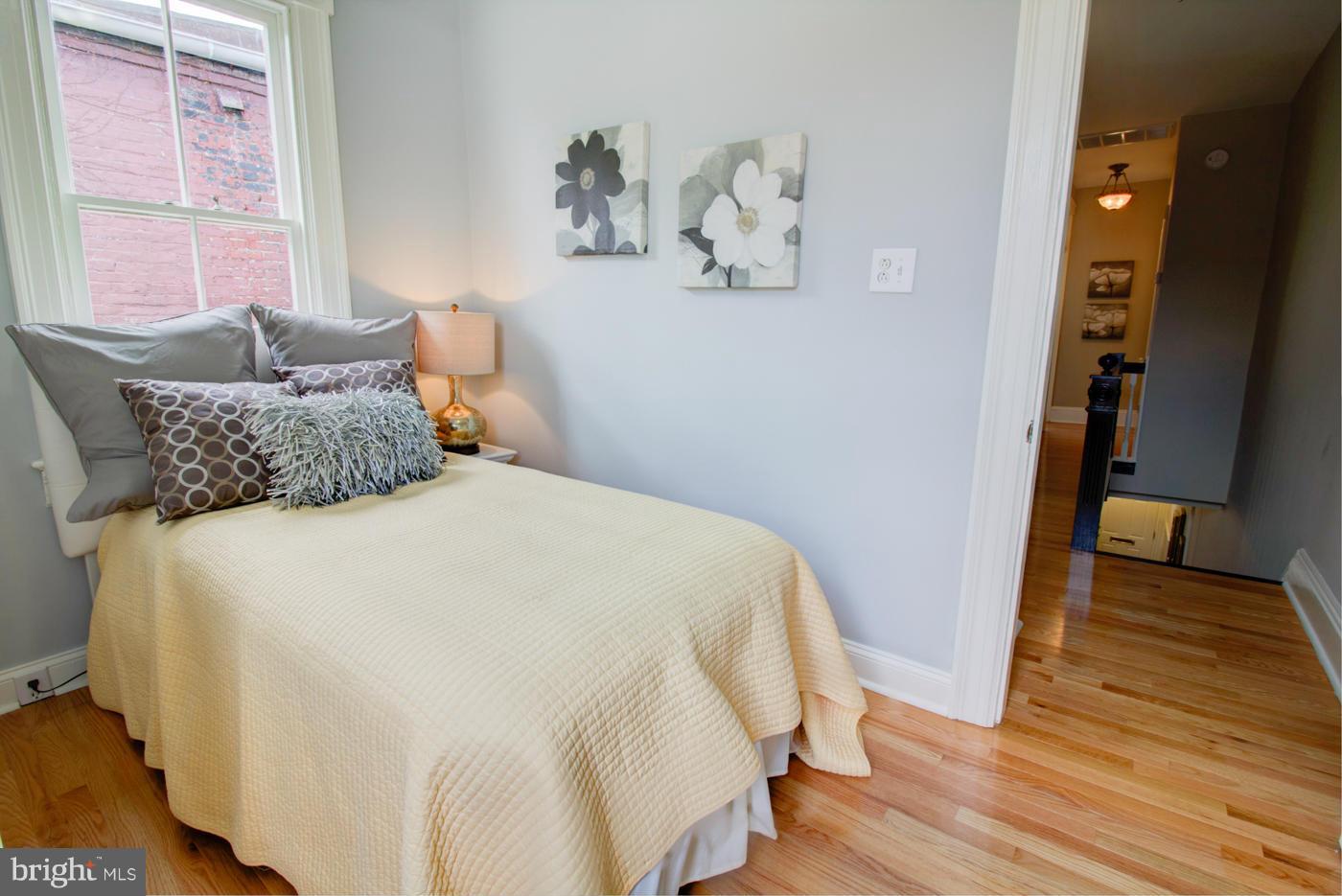 509 6th Street Northeast Washington, DC 20002 - Photo 16 of 30 a bedroom with a bed and wooden floor