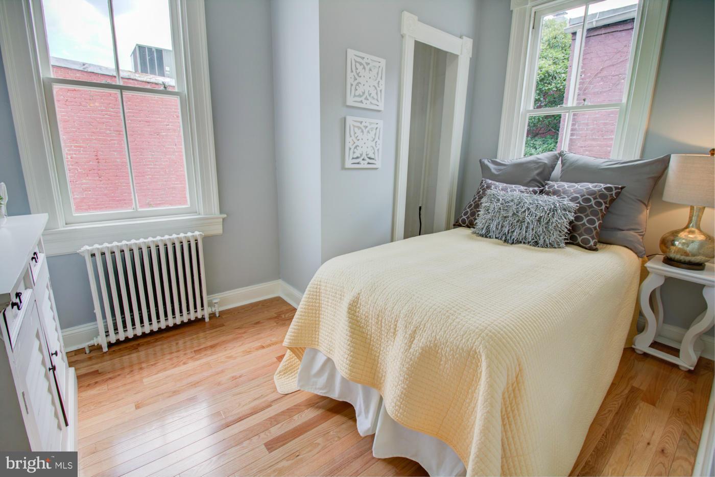 509 6th Street Northeast Washington, DC 20002 - Photo 17 of 30 a bedroom with a bed and wooden floor