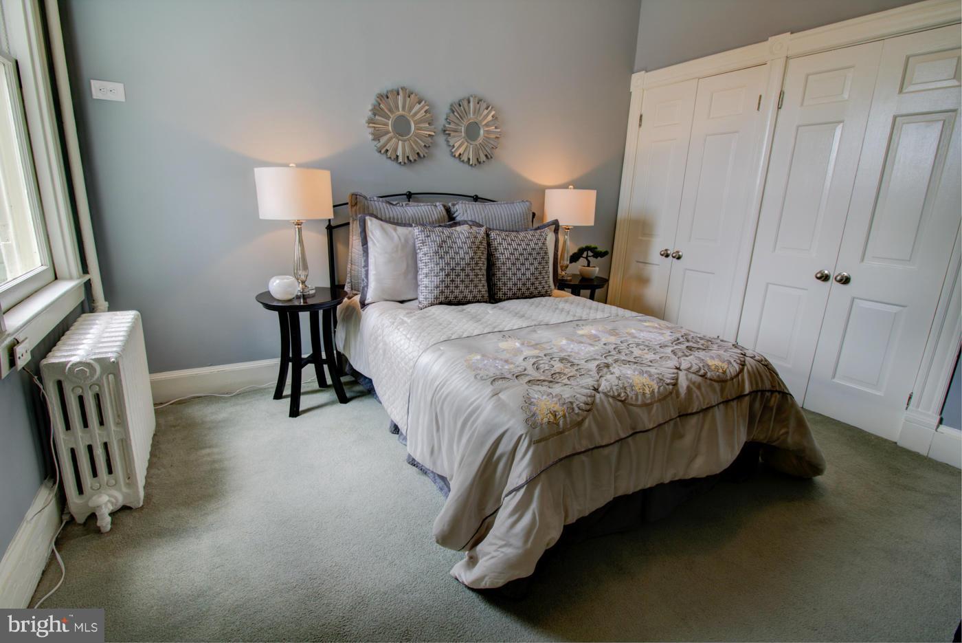 509 6th Street Northeast Washington, DC 20002 - Photo 22 of 30 a bedroom with a bed and a chandelier