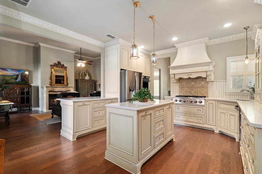326 West Liberty Street Pilot Point, TX 76258 - Photo 12 of 40 a kitchen with white cabinets and stainless steel appliances