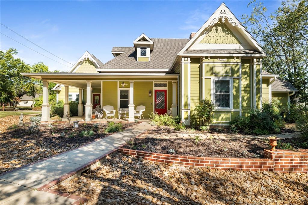 326 West Liberty Street Pilot Point, TX 76258 - Photo 2 of 40 a front view of a house with garden