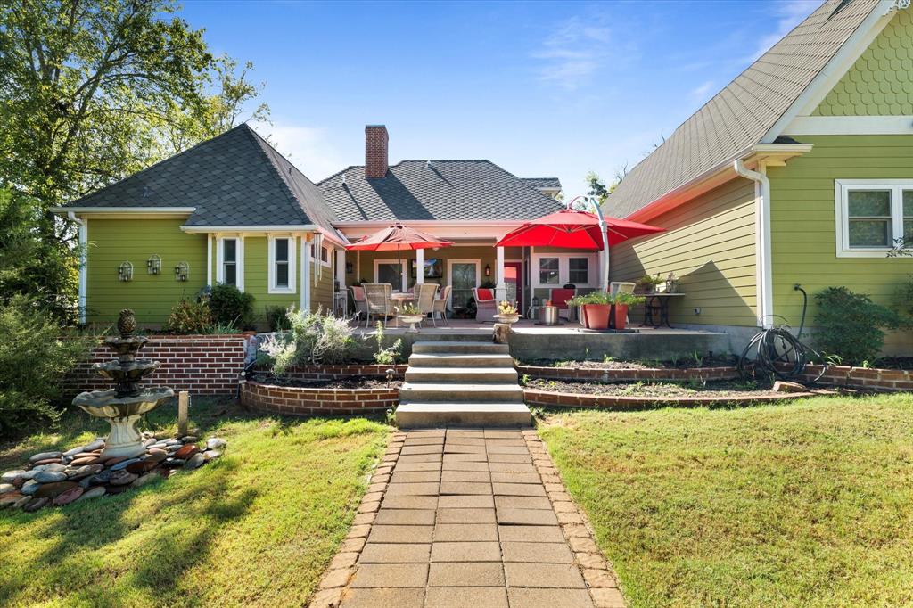 326 West Liberty Street Pilot Point, TX 76258 - Photo 34 of 40 a front view of a house with swimming pool and a yard