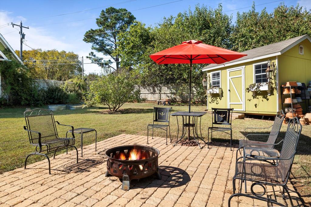 326 West Liberty Street Pilot Point, TX 76258 - Photo 37 of 40 a view of a roof deck with table and chairs under an umbrella