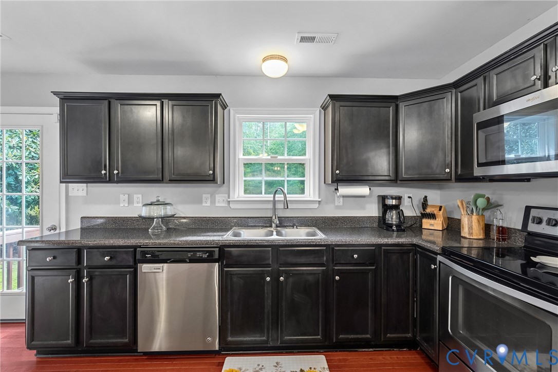 17045 Annfield Road Beaverdam, VA 23015 - Photo 15 of 40 Dark wood-finish cabinetry with crown molding, sta
