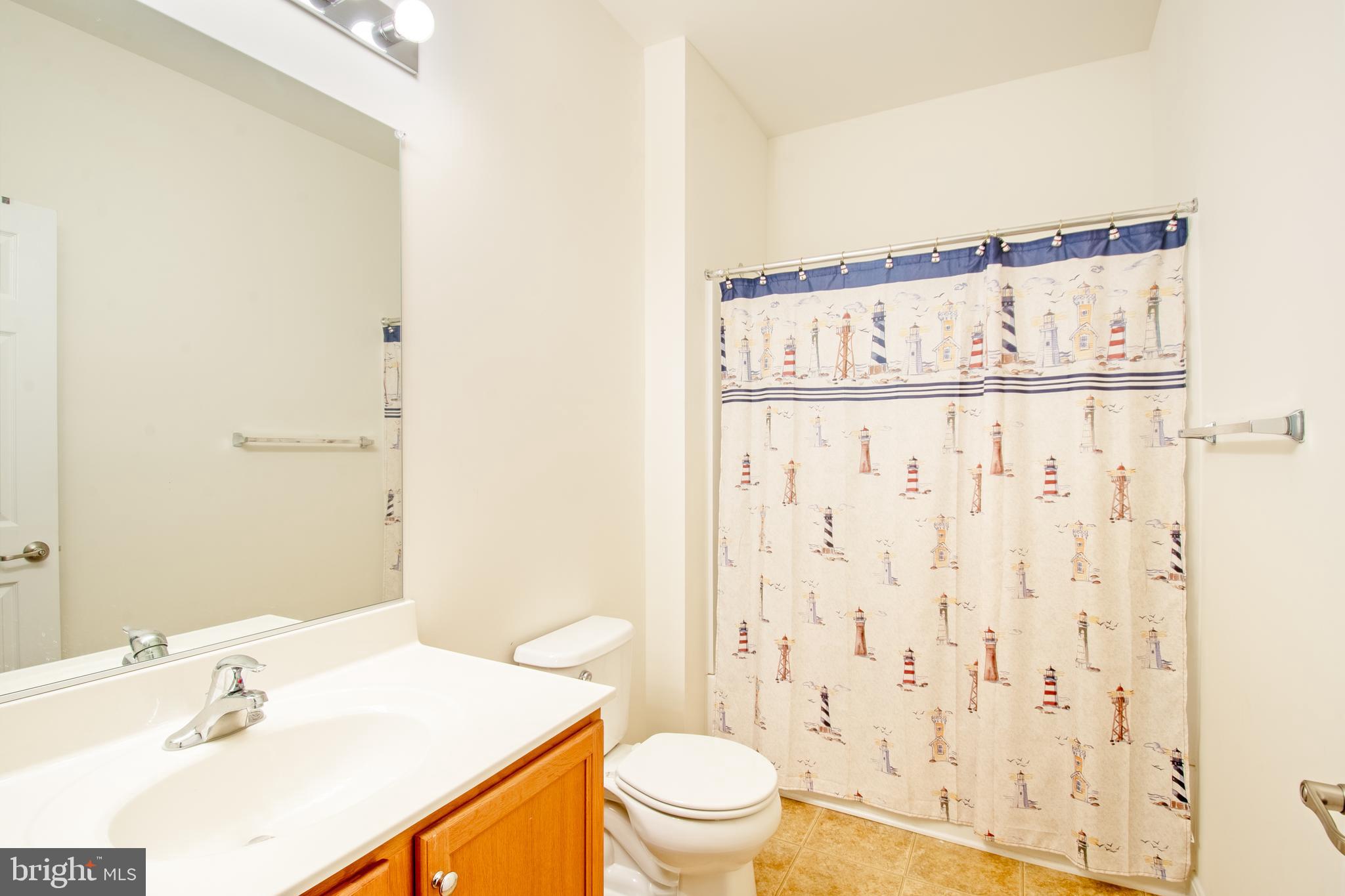 85 Bay Hill Road Magnolia, DE 19962 - Photo 27 of 31 a bathroom with a sink a toilet and shower curtain
