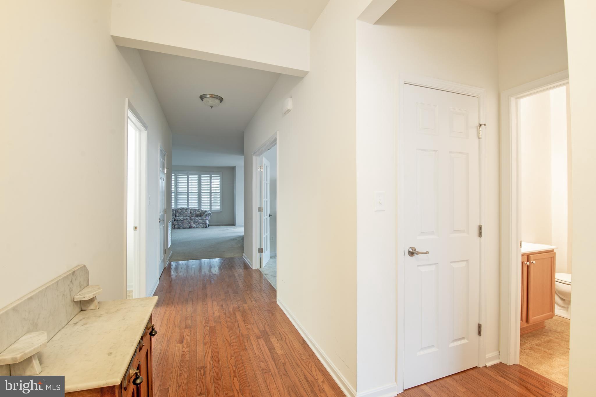 85 Bay Hill Road Magnolia, DE 19962 - Photo 7 of 31 a view of a hallway with wooden floor and a bathroom
