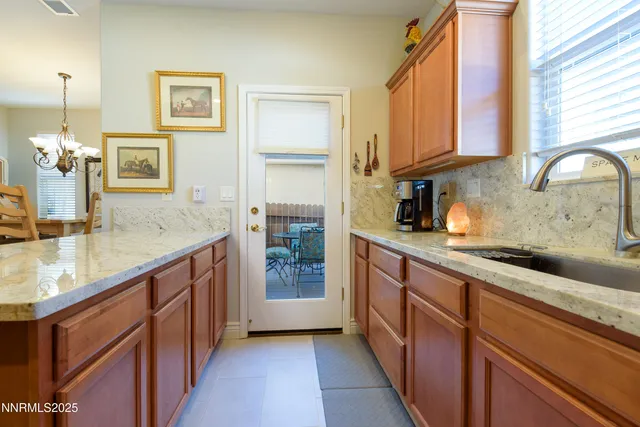 a kitchen with stainless steel appliances granite countertop a sink and cabinets
