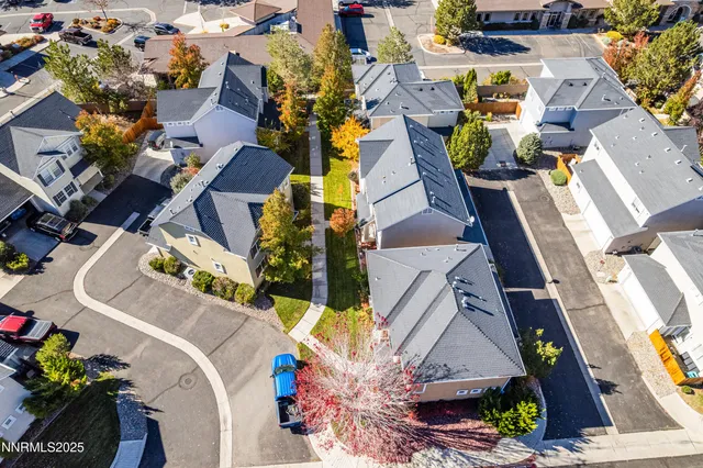 an aerial view of multiple houses with yard