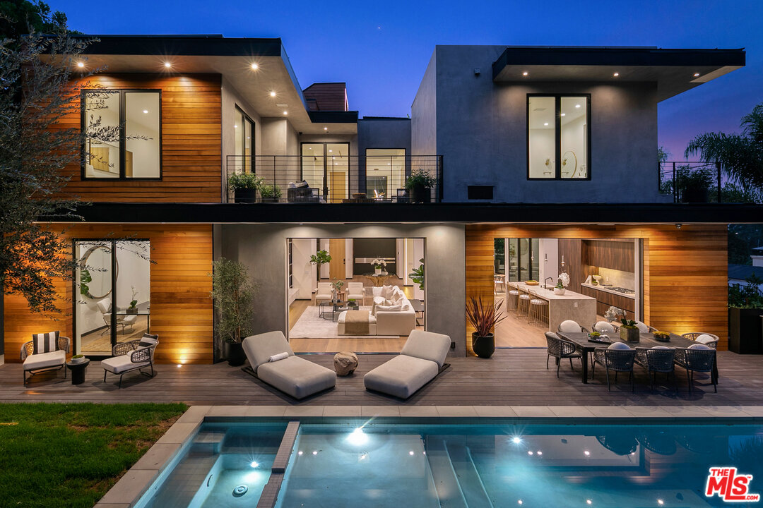 a view of a chairs and table in backyard