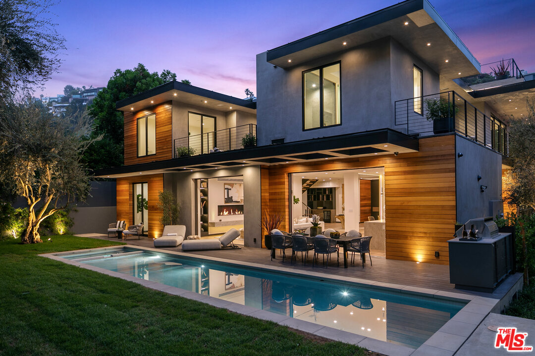 1461 Rising Glen Road Los Angeles, CA 90069 - Photo 2 of 22 a view of a chairs and table in backyard