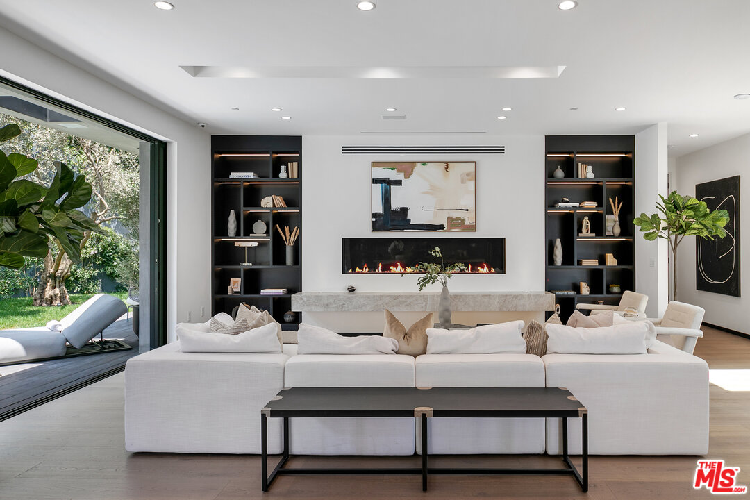 1461 Rising Glen Road Los Angeles, CA 90069 - Photo 11 of 22 a living room with furniture a rug and a large window