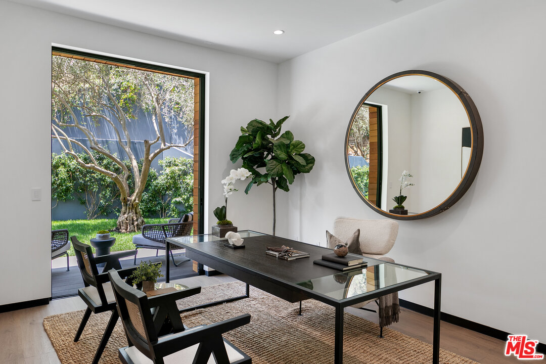 1461 Rising Glen Road Los Angeles, CA 90069 - Photo 14 of 22 a living room with a table and a potted plant