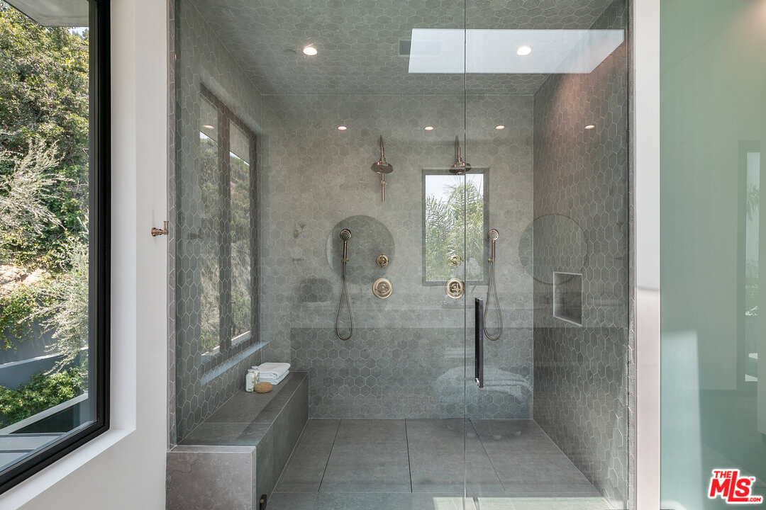 1461 Rising Glen Road Los Angeles, CA 90069 - Photo 17 of 22 a bathroom with a glass shower door and a sink