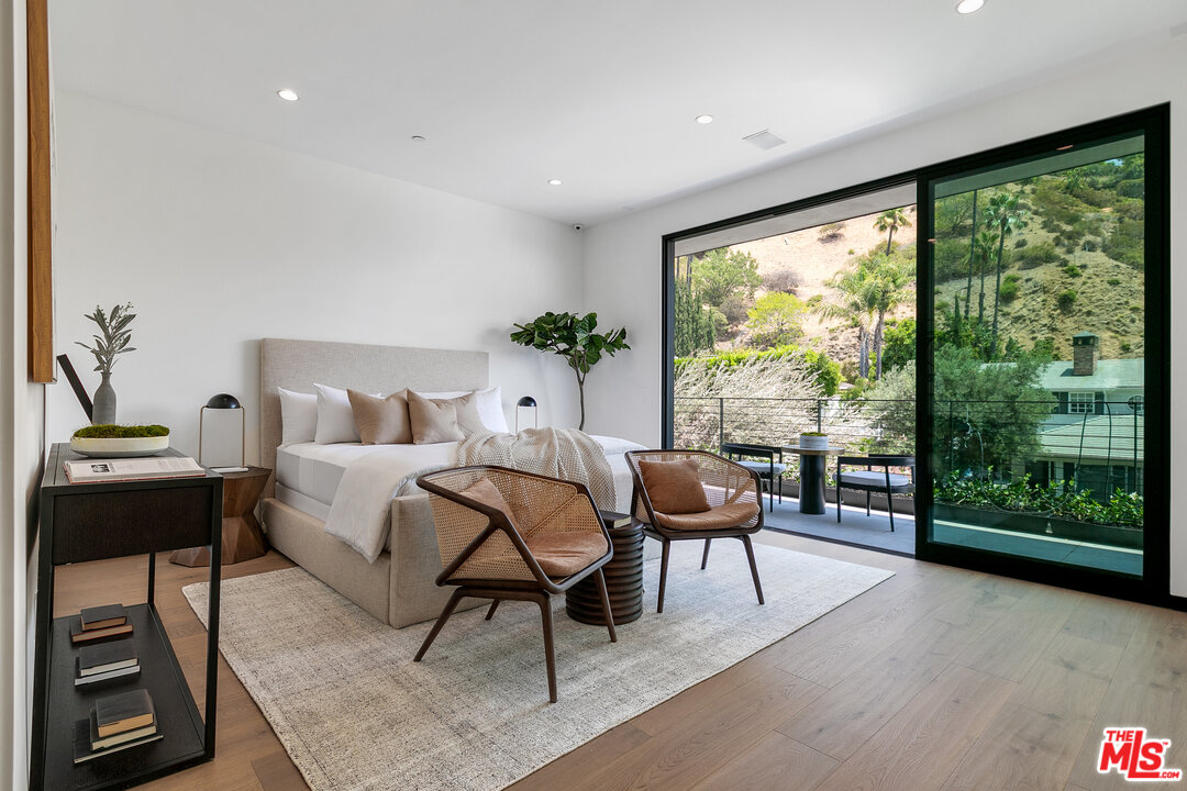 1461 Rising Glen Road Los Angeles, CA 90069 - Photo 19 of 22 a living room with furniture and a large window
