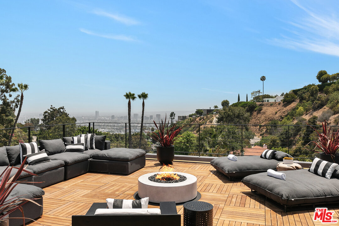 1461 Rising Glen Road Los Angeles, CA 90069 - Photo 21 of 22 a living room with furniture and a large window