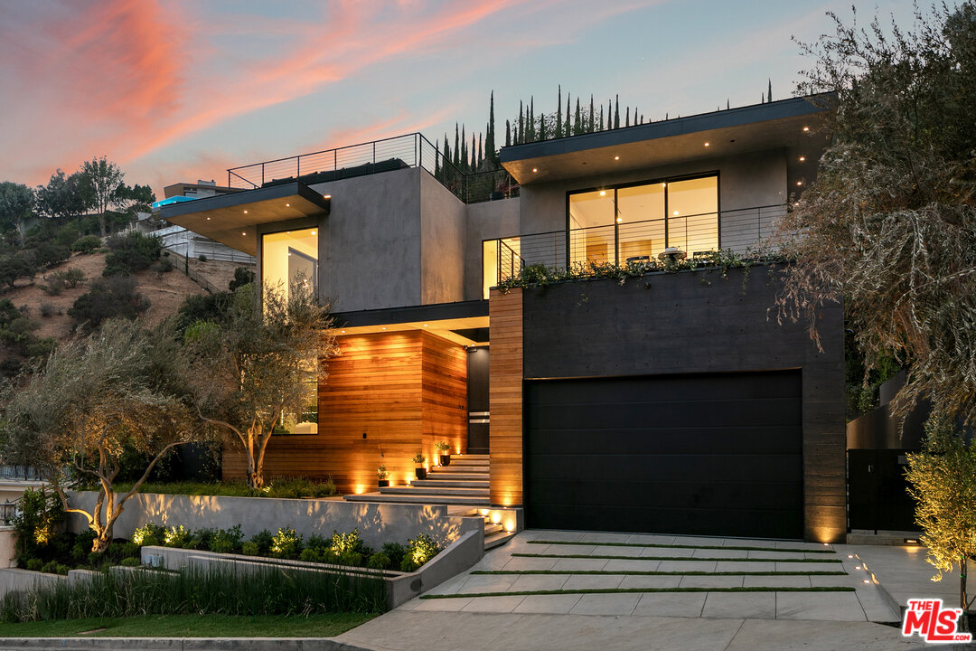 1461 Rising Glen Road Los Angeles, CA 90069 - Photo 4 of 22 a front view of a house with a yard
