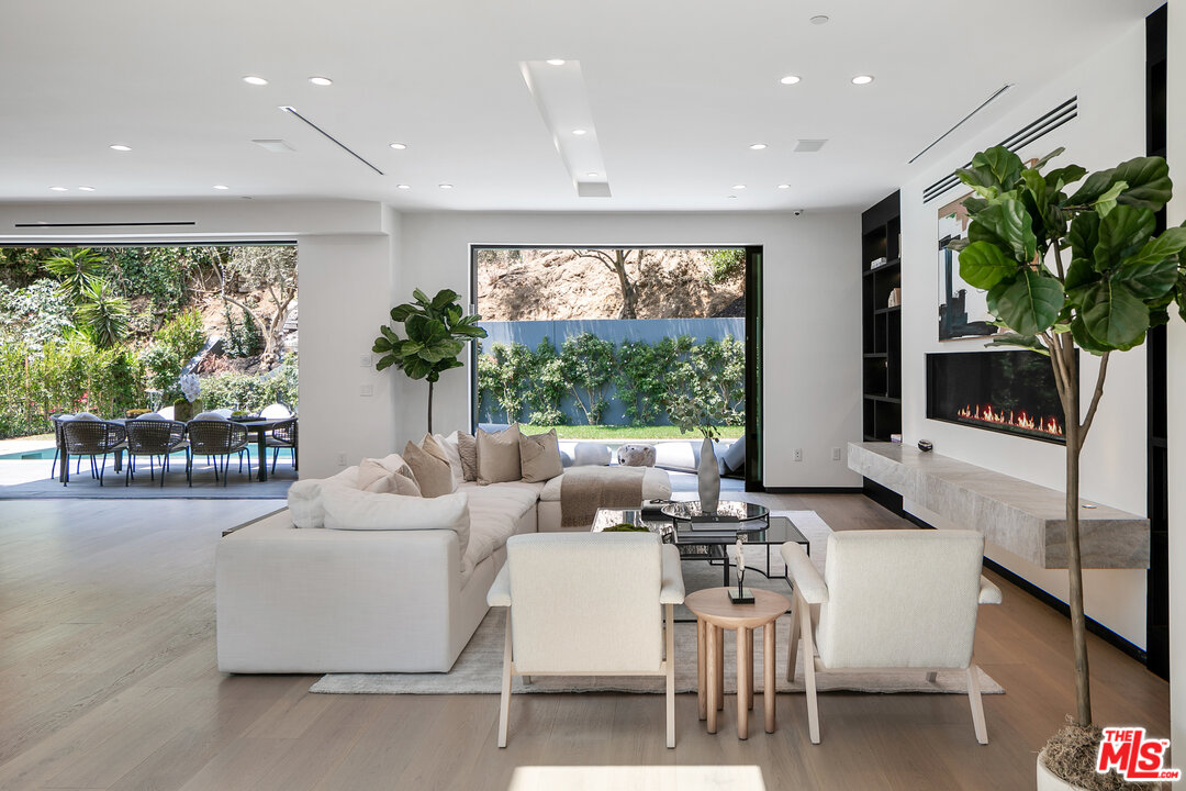 1461 Rising Glen Road Los Angeles, CA 90069 - Photo 10 of 22 a living room with furniture a large window and a potted plant