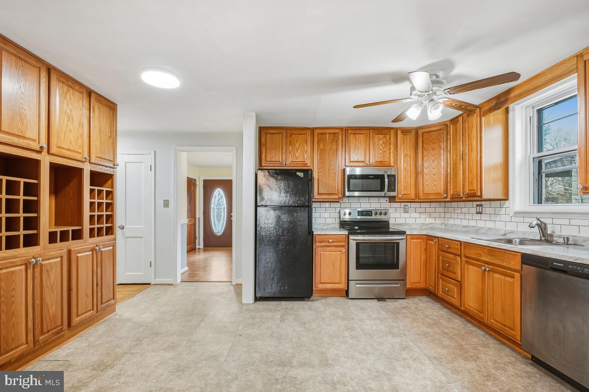 4810 Odell Road Beltsville, MD 20705 - Photo 11 of 30 a kitchen with stainless steel appliances granite countertop a stove refrigerator sink and dishwasher