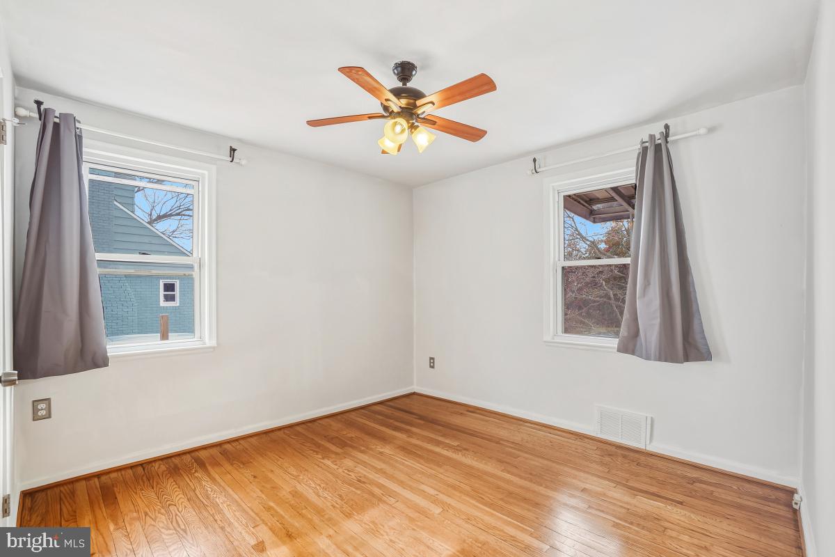 4810 Odell Road Beltsville, MD 20705 - Photo 18 of 30 a view of an empty room with window and wooden floor