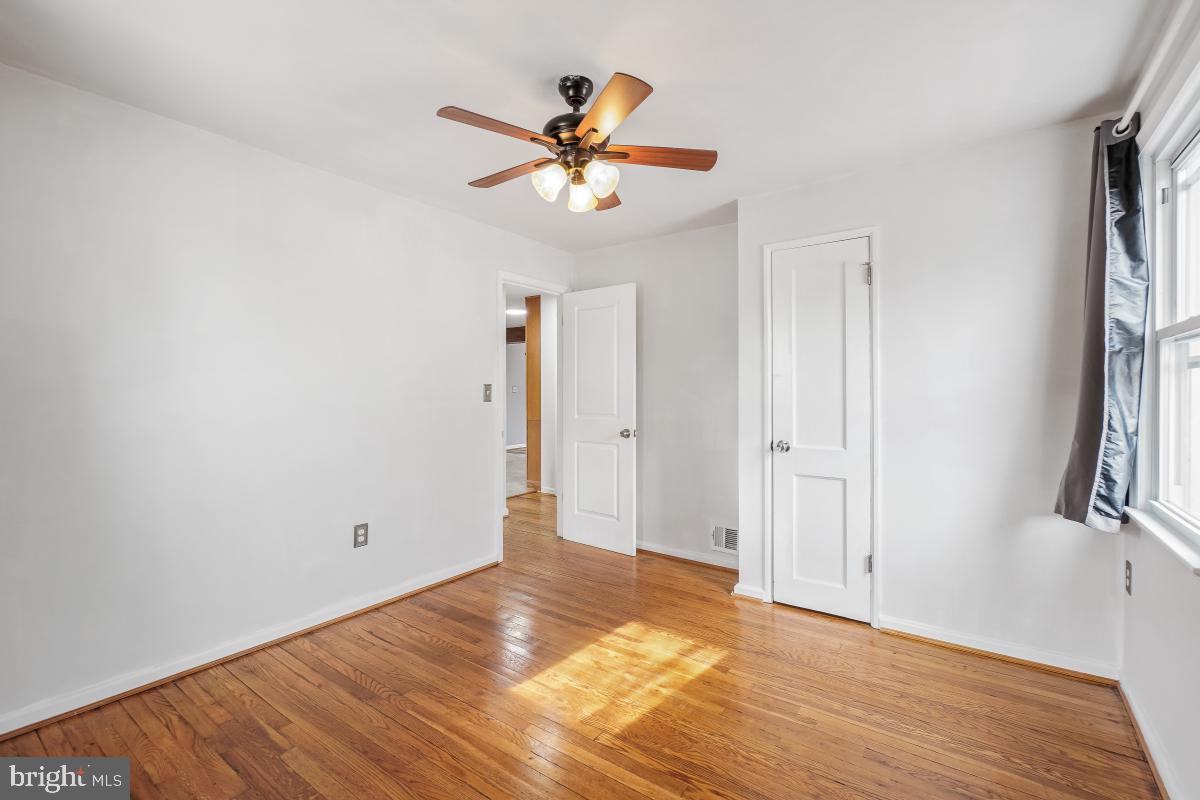 4810 Odell Road Beltsville, MD 20705 - Photo 19 of 30 a view of an empty room with wooden floor and a ceiling fan