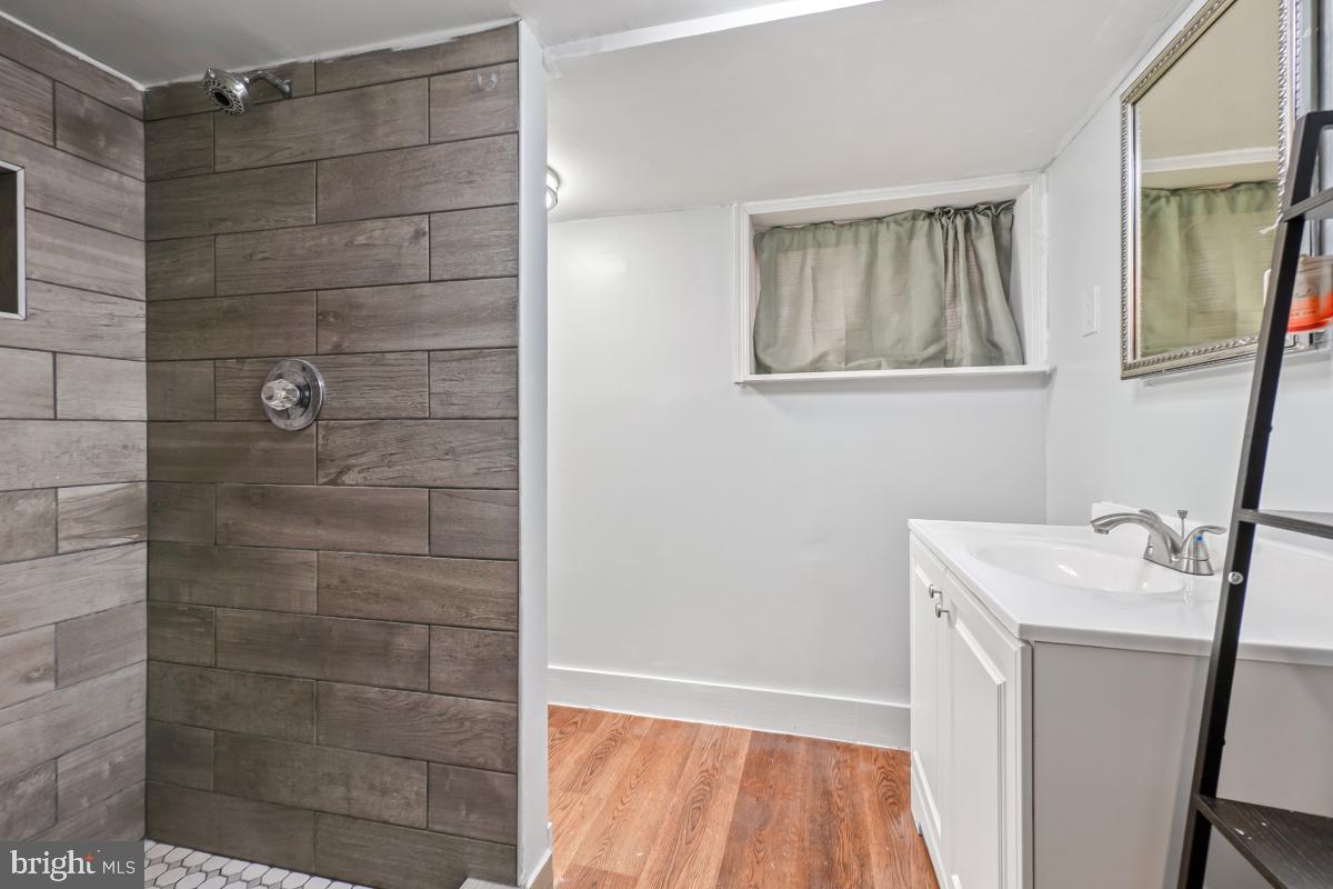 4810 Odell Road Beltsville, MD 20705 - Photo 21 of 30 a bathroom with a sink a vanity and a shower