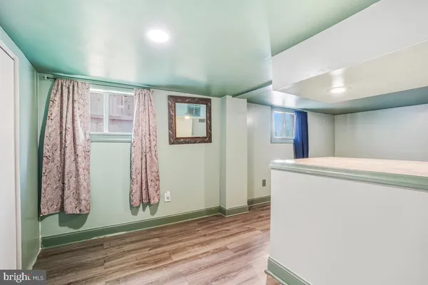 a view of a kitchen with wooden floor and a sink