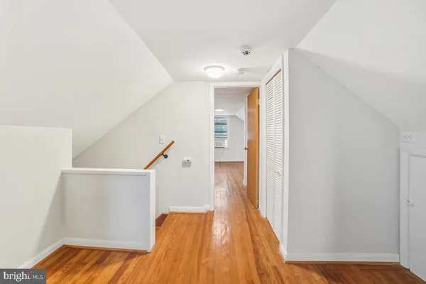 a view of a room with wooden floor and windows