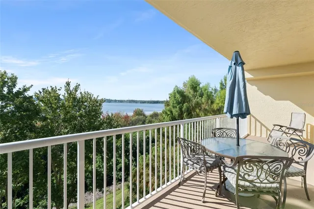 a balcony with table and chairs