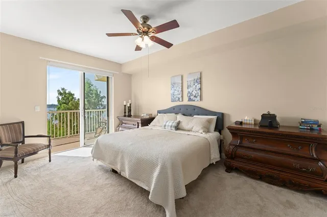 a spacious bedroom with a bed and a chandelier