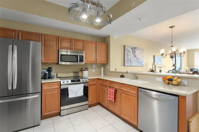a kitchen with stainless steel appliances granite countertop a sink and a refrigerator