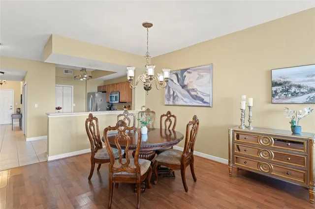 a view of a dining room with furniture wooden floor and a chandelier