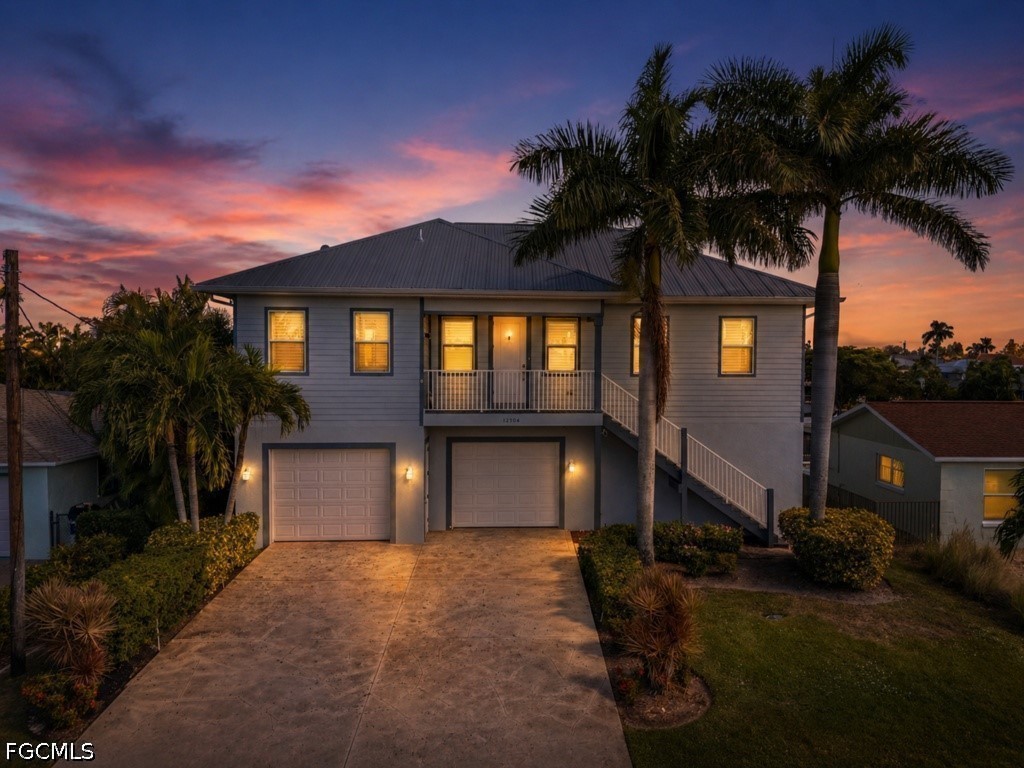 12304 Boat Shell Drive Matlacha Isles, FL 33991 - Photo 1 of 49 a front view of a house with a yard