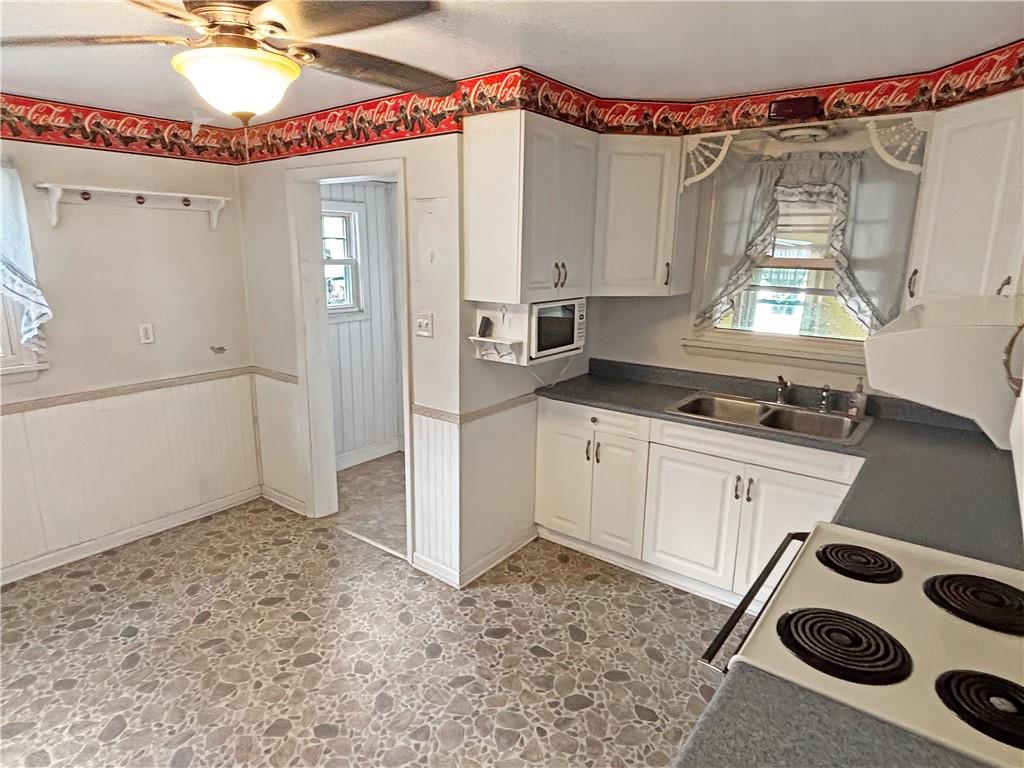 1701 Indiana Avenue Monaca, PA 15061 - Photo 12 of 33 a kitchen with a stove a sink and a refrigerator