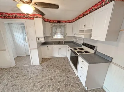 a kitchen with stainless steel appliances a stove a sink and a refrigerator