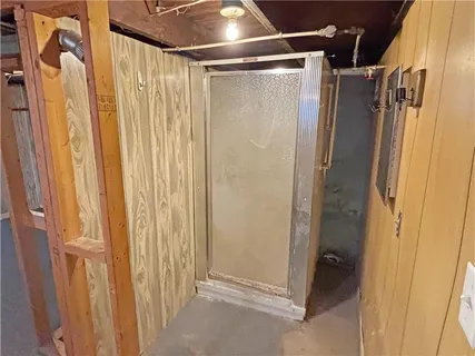 a bathroom with a shower and a glass door