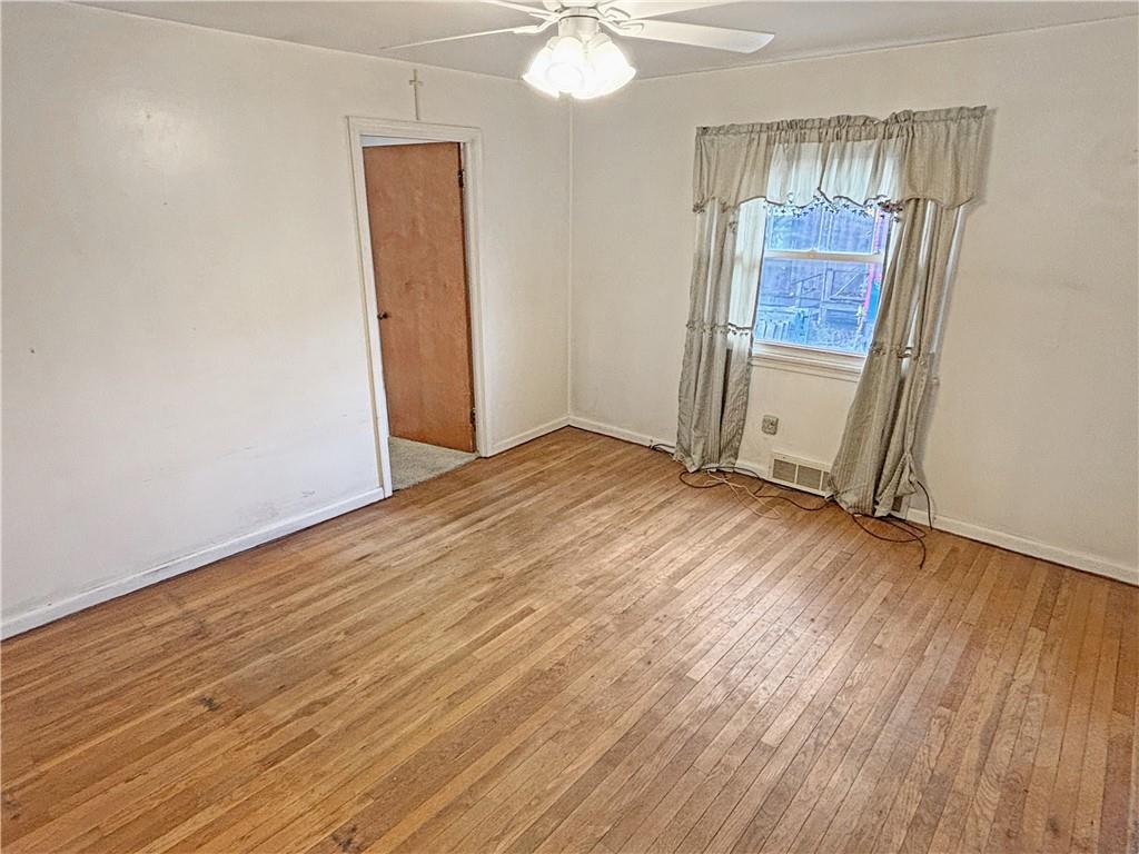 1701 Indiana Avenue Monaca, PA 15061 - Photo 8 of 33 an empty room with wooden floor and door