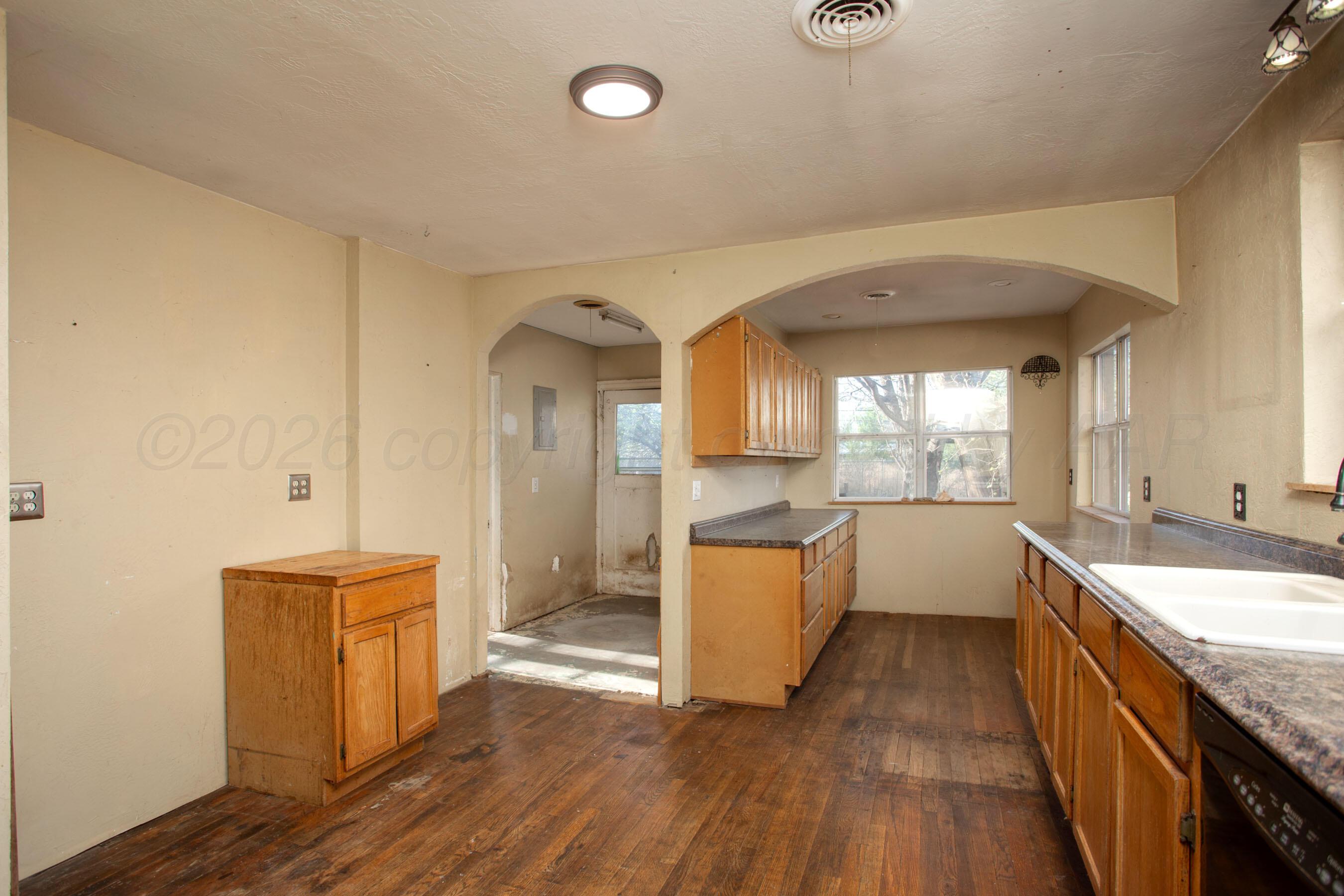 4223 Southwest 11th Avenue Amarillo, TX 79106 - Photo 11 of 26 a large room with a large window and wooden floor